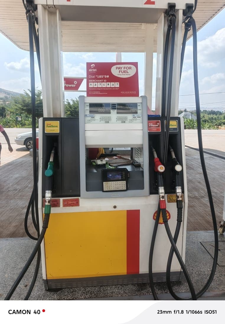 Shell fuel dispenser with FuelSave and V-Power nozzles under a station canopy