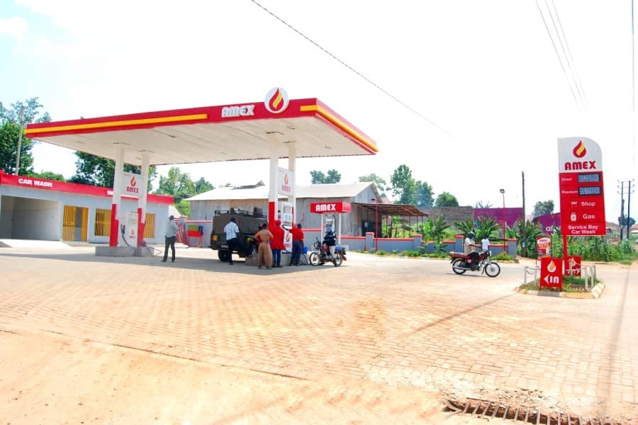 Completed AMEX petrol station with canopy, pumps, car wash, and price pylon